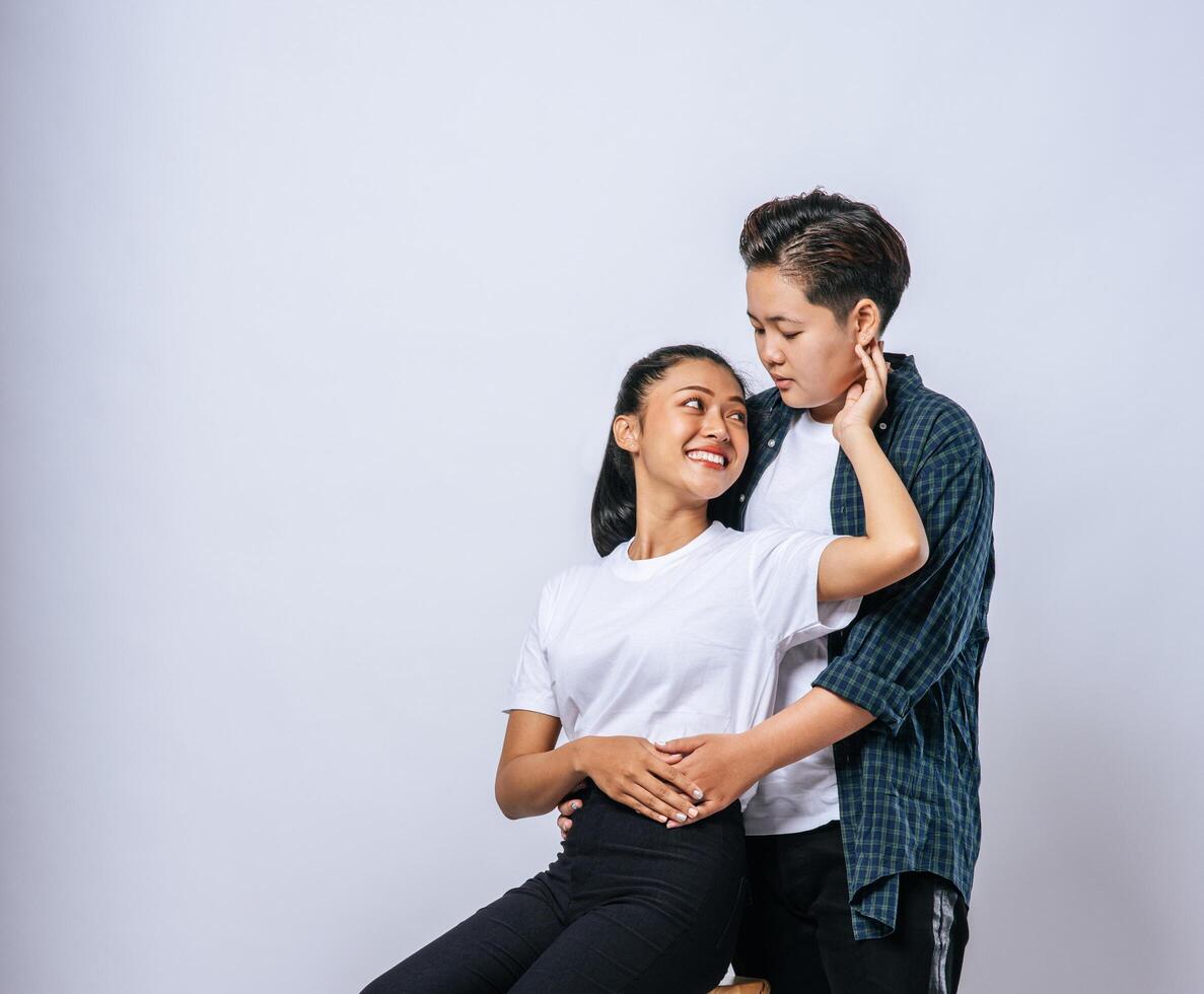 Two female lovers standing and hugging from behind. photo