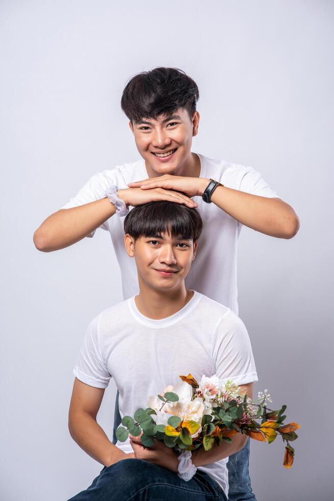 The two men who loved each other held their heads and sat on a chair. photo