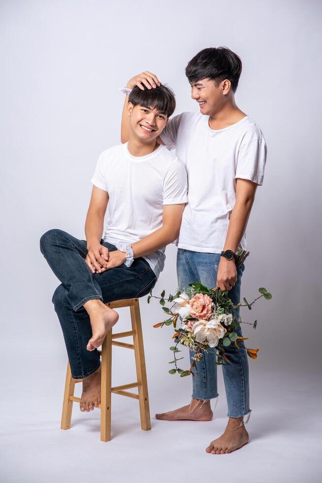 The two men who loved each other held their heads and sat on a chair. photo