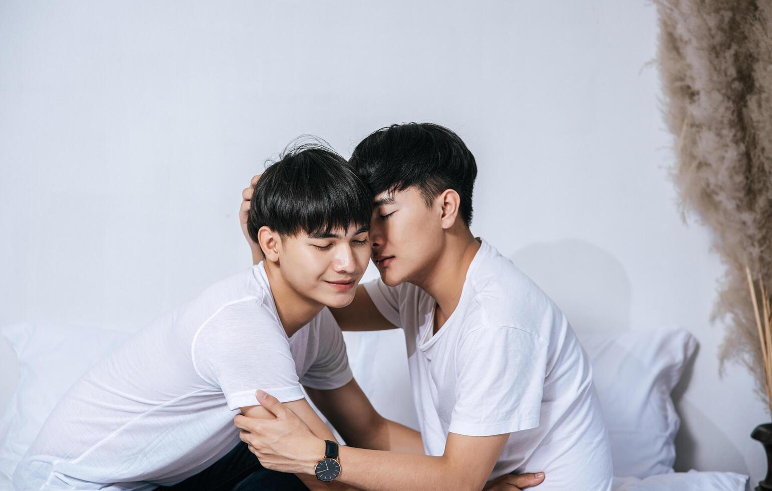 Two loving young men hugged and fragrant cheek each other. photo