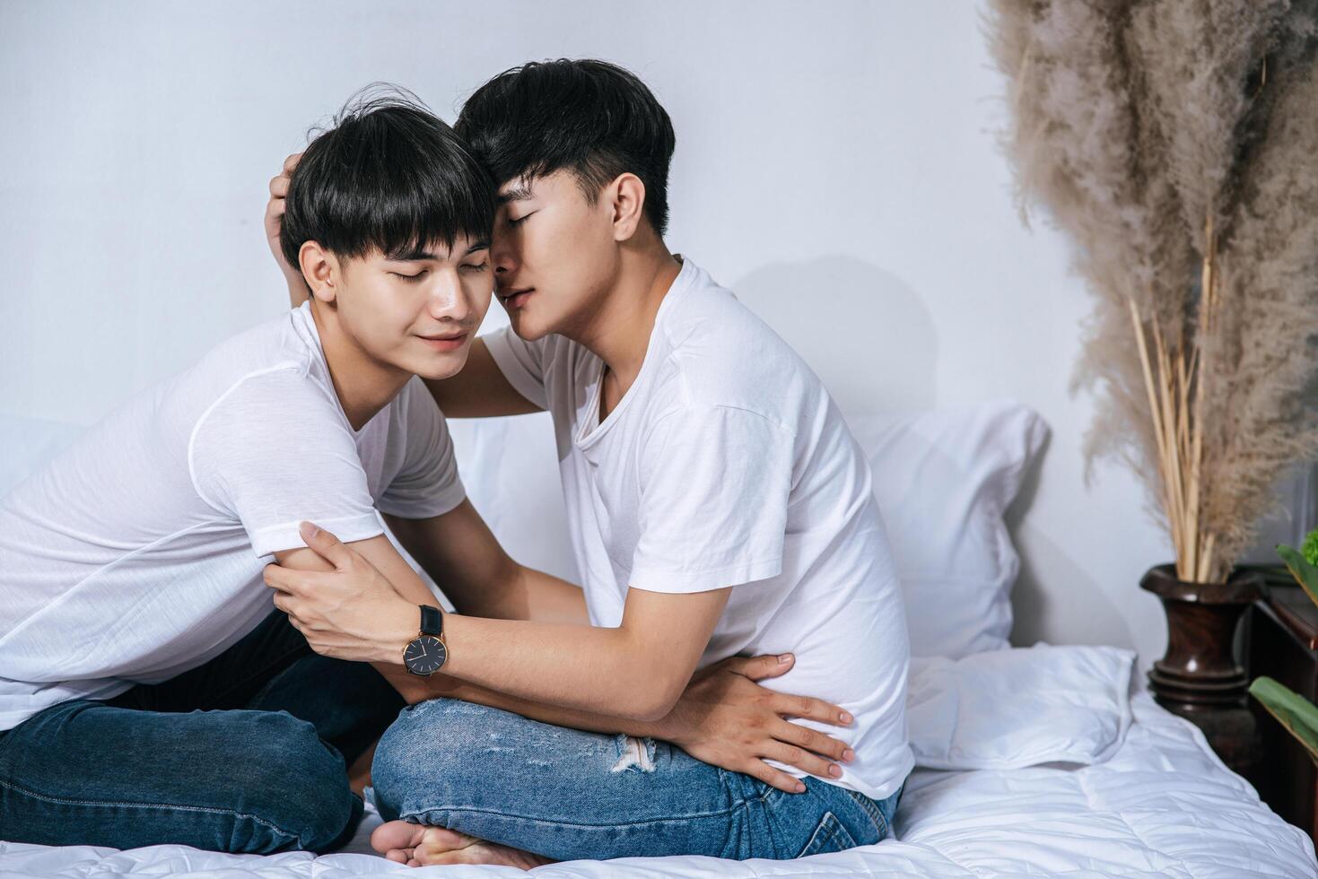 Two loving young men hugged and fragrant cheek each other. photo