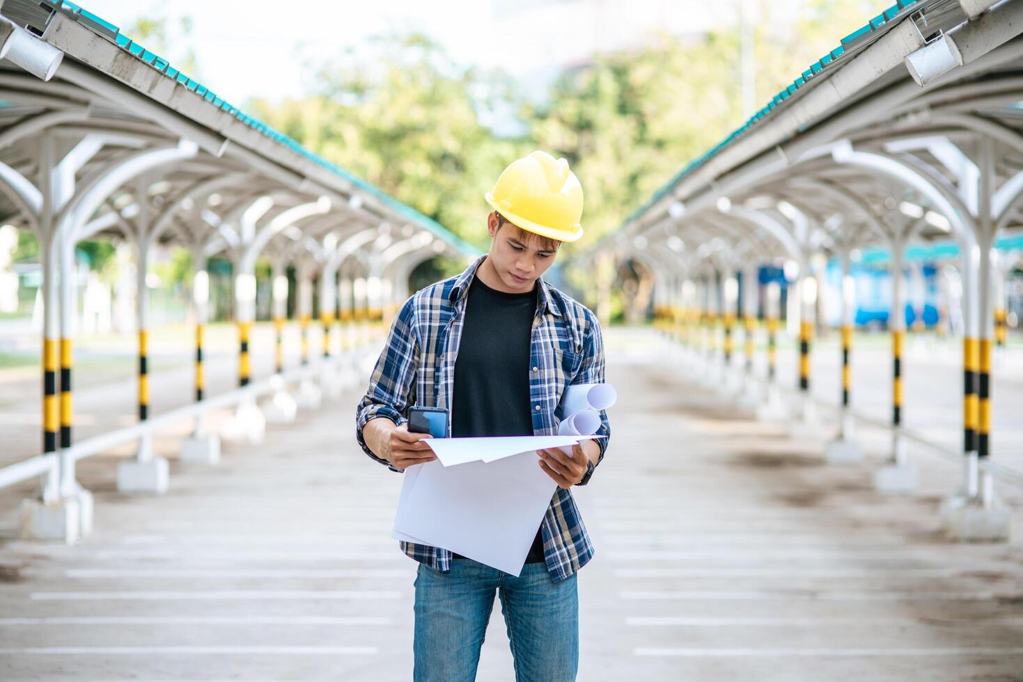 Architects hold the building plan and check the work. photo
