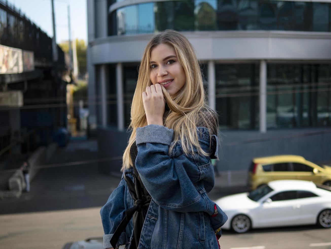 Grl smiling in a denim jacket photo