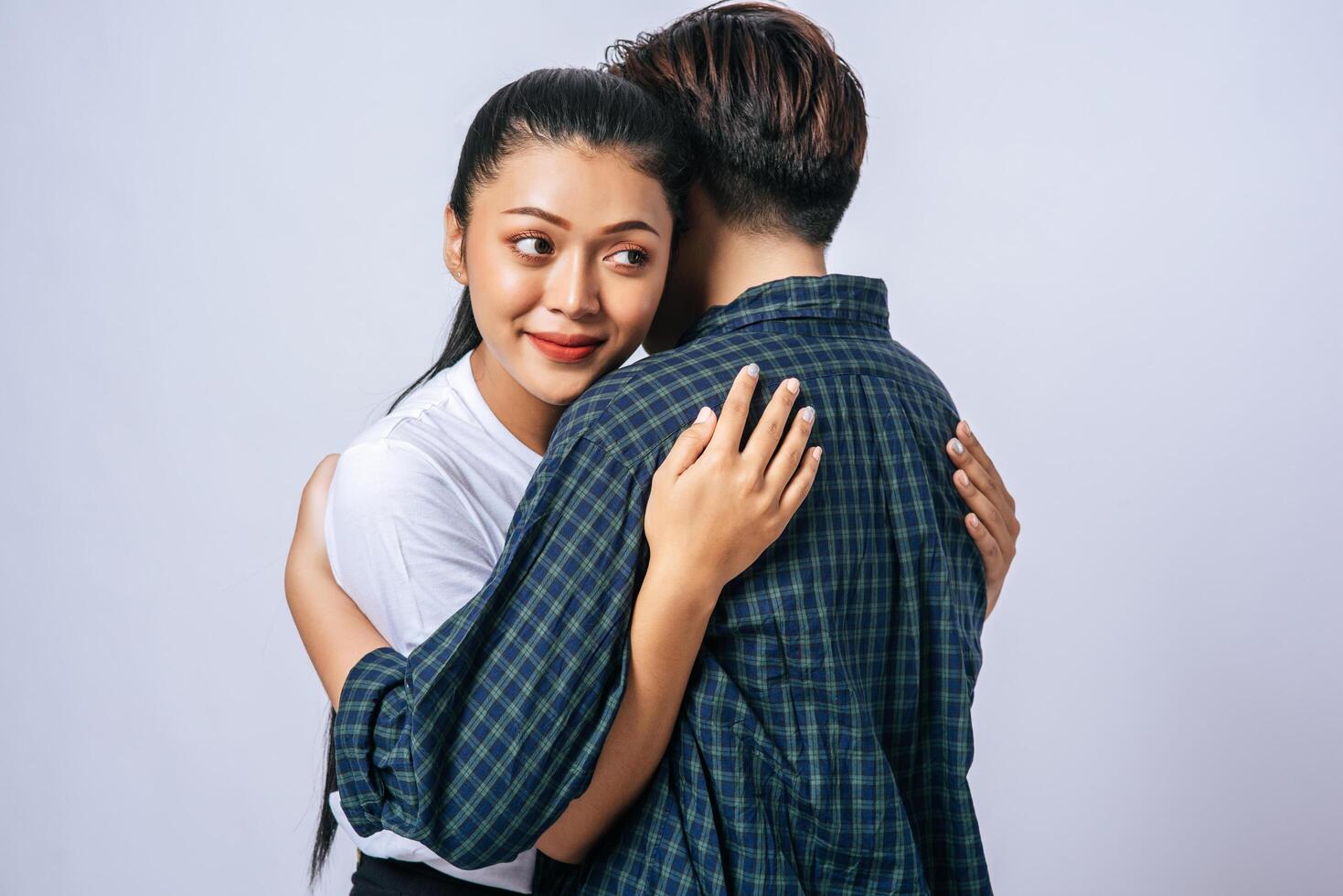 Two female couples standing and hugging each other. photo