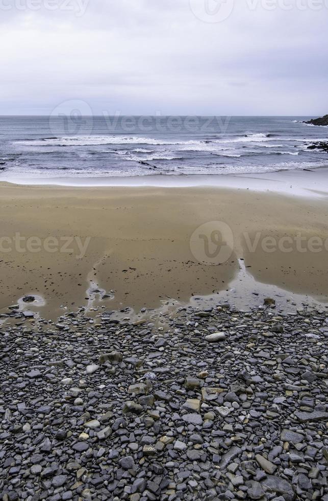 Stones in sand beach photo