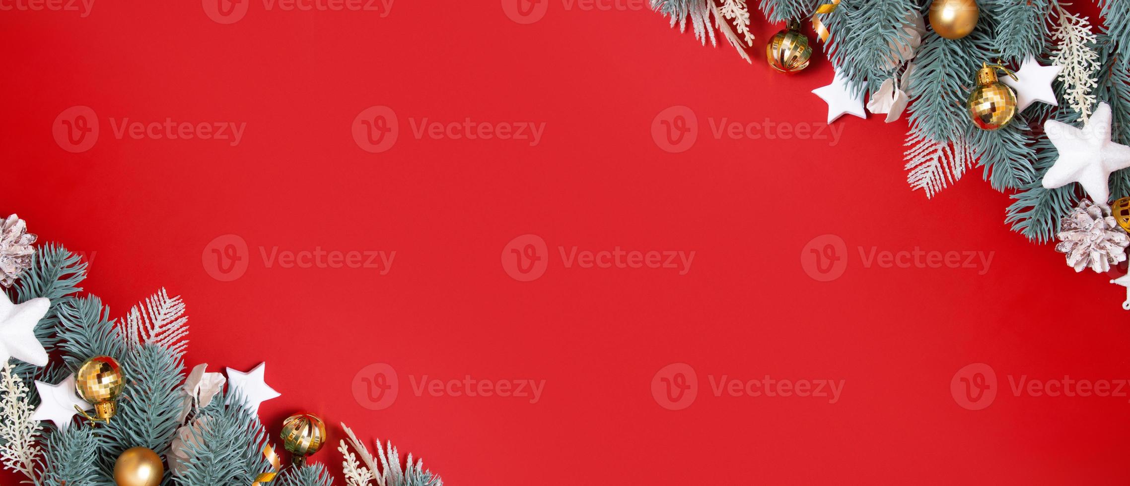 Banner with flat lay christmas decorations on red background with copy space for winter holidays greetings photo