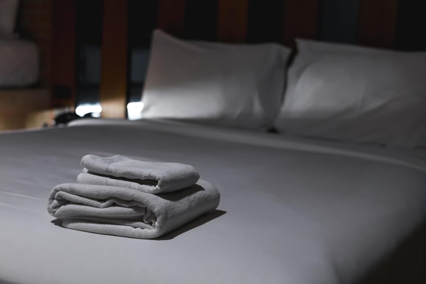 The towels are folded and placed on the bed for the hotel guests. photo