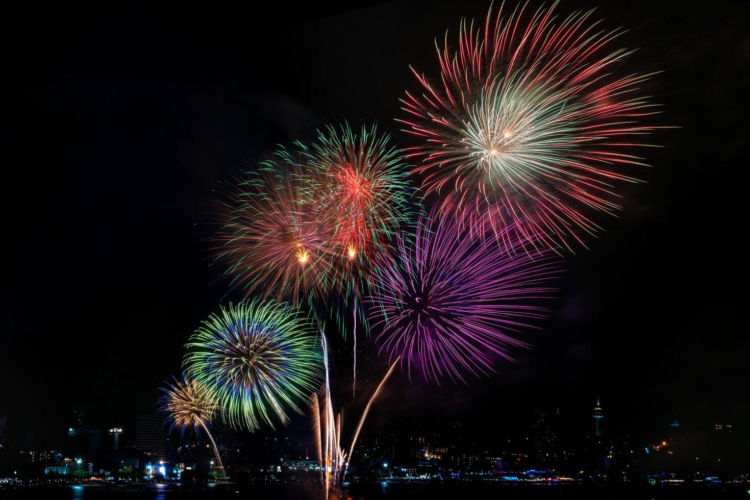 Colorful fireworks of various colors at night with celebration and anniversary concept photo