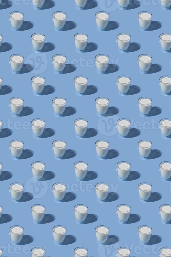 World Milk Day. pattern on a blue background. A glass of milk. Sample.Vertical format photo