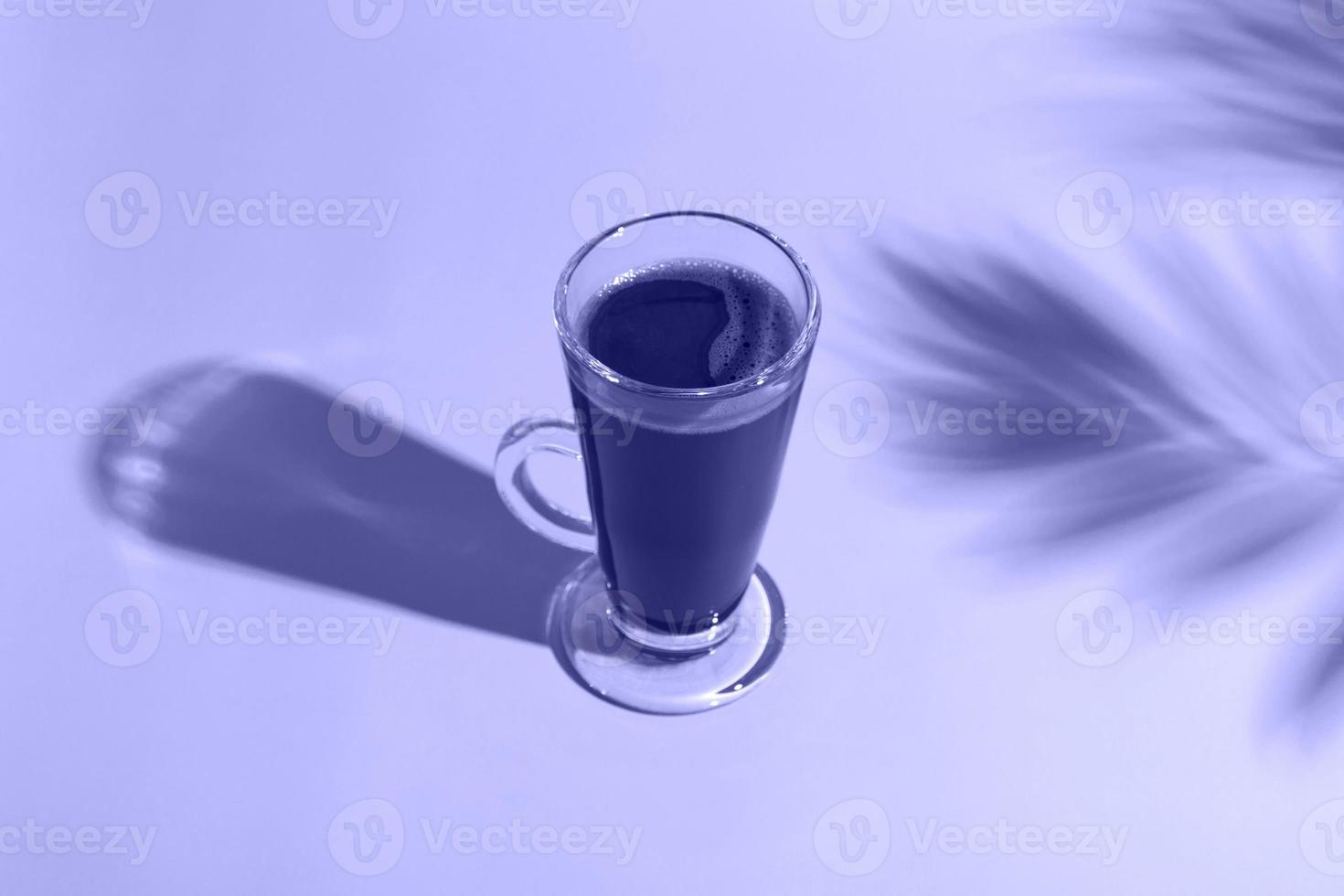 Hot chocolate on a very peri background, in the shade of a palm tree. World chocolate day concept.  holiday of chocolate photo