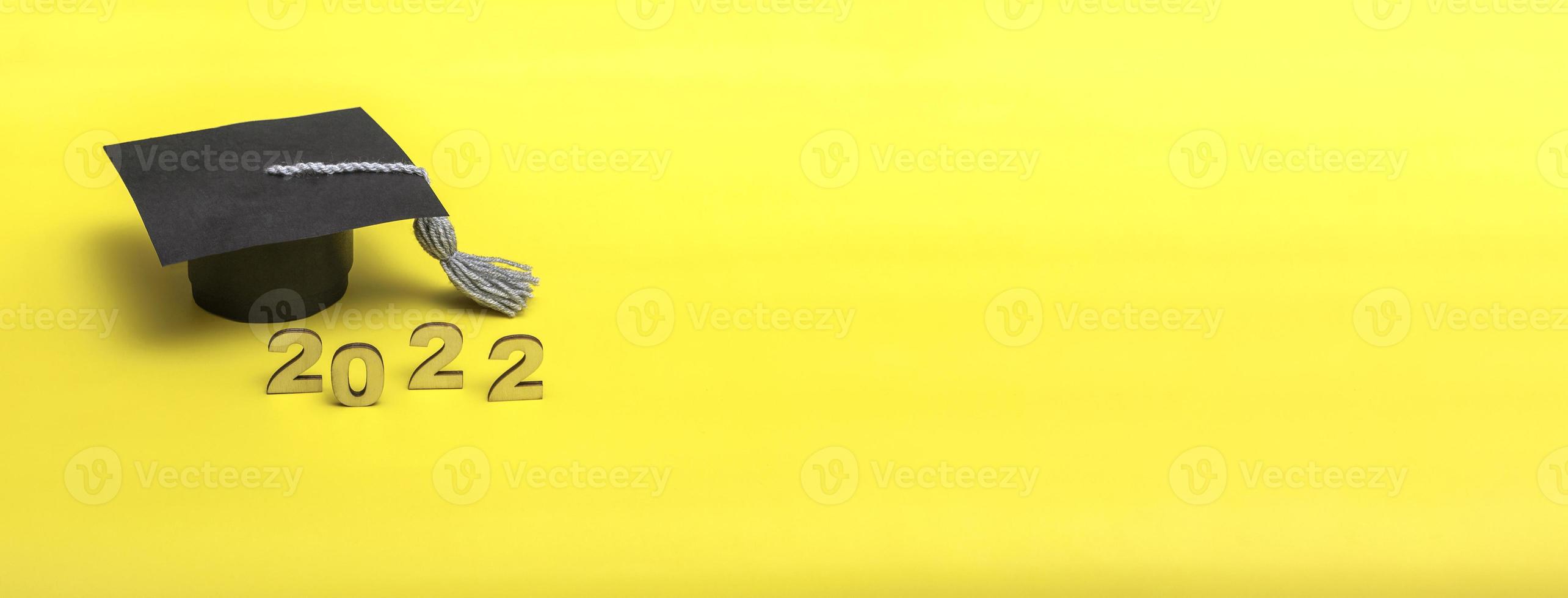 Gift box in the form of a graduation cap. 2022 release concept on yellow background copy space. Banner photo