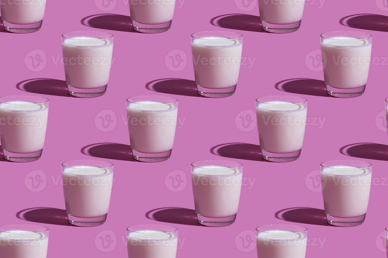 World Milk Day. Pattern on a pink background. A glass of milk. Pattern. photo