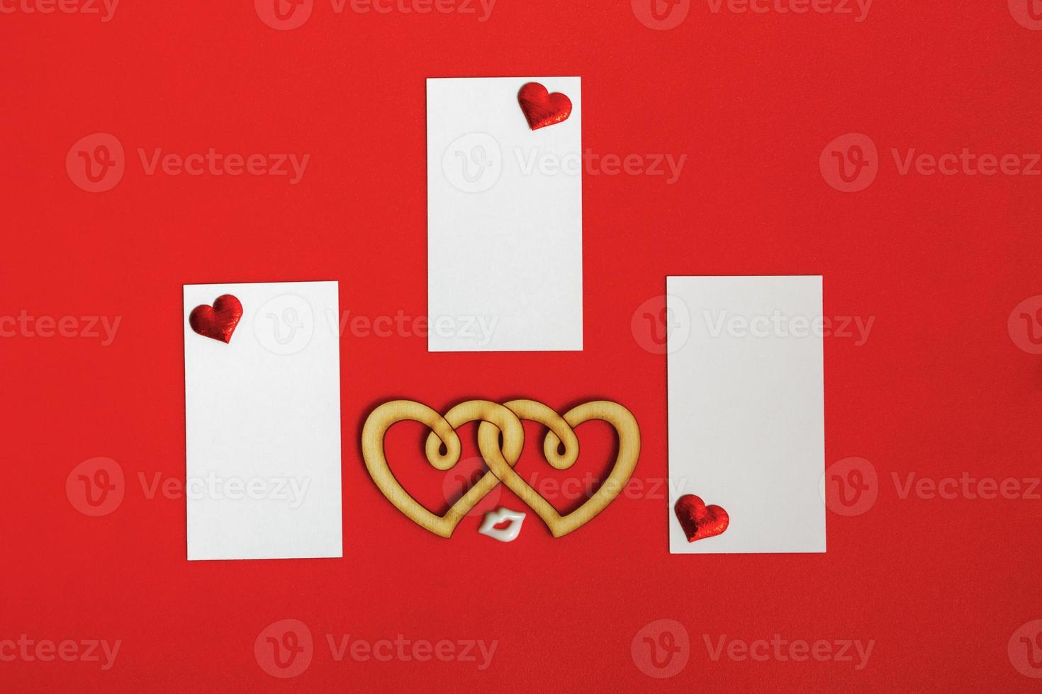 Blank cards with hearts on a red background. Valentine's day concept. photo