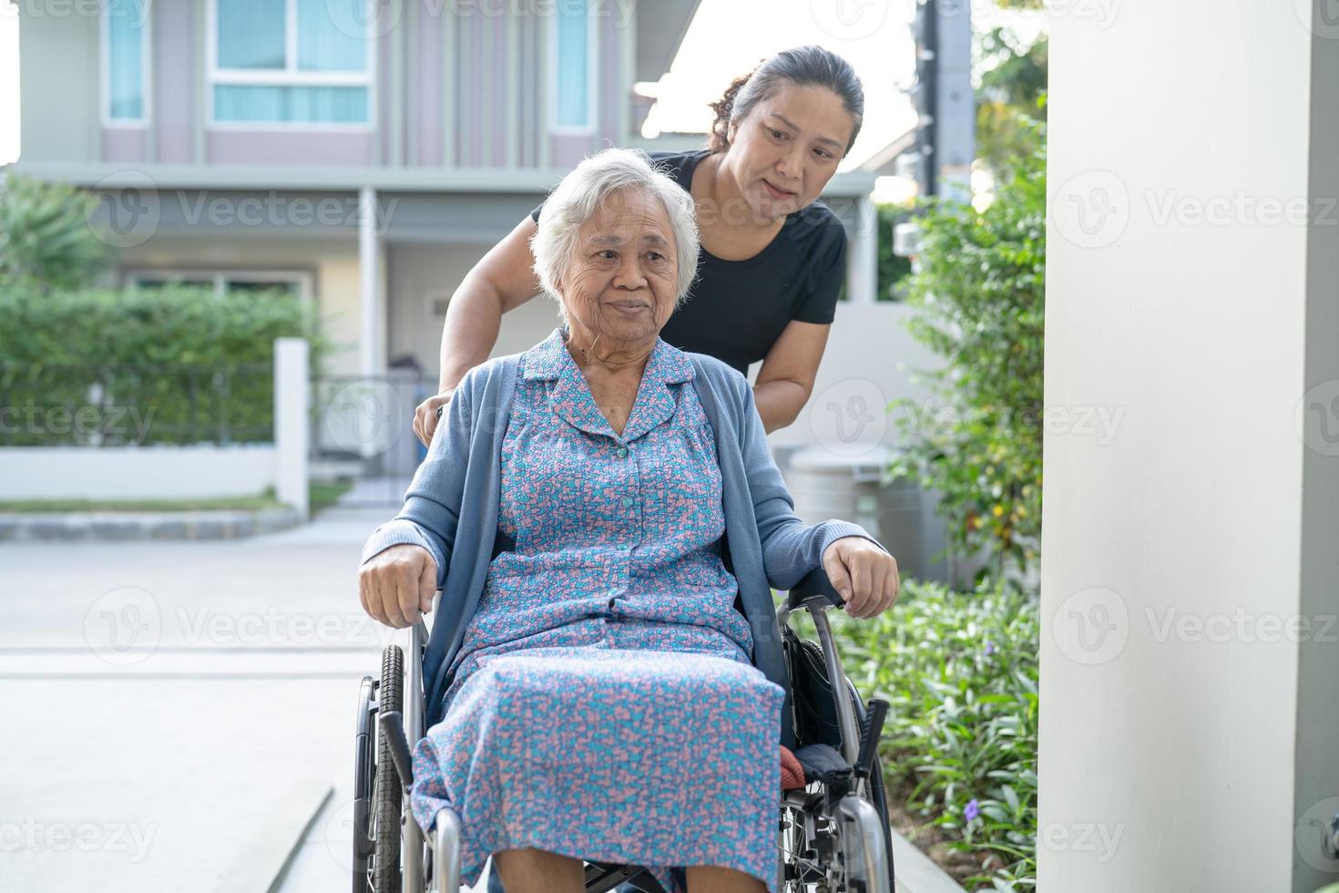 Caregiver help and care Asian senior or elderly old lady woman patient sitting on wheelchair at nursing hospital ward, healthy strong medical concept photo