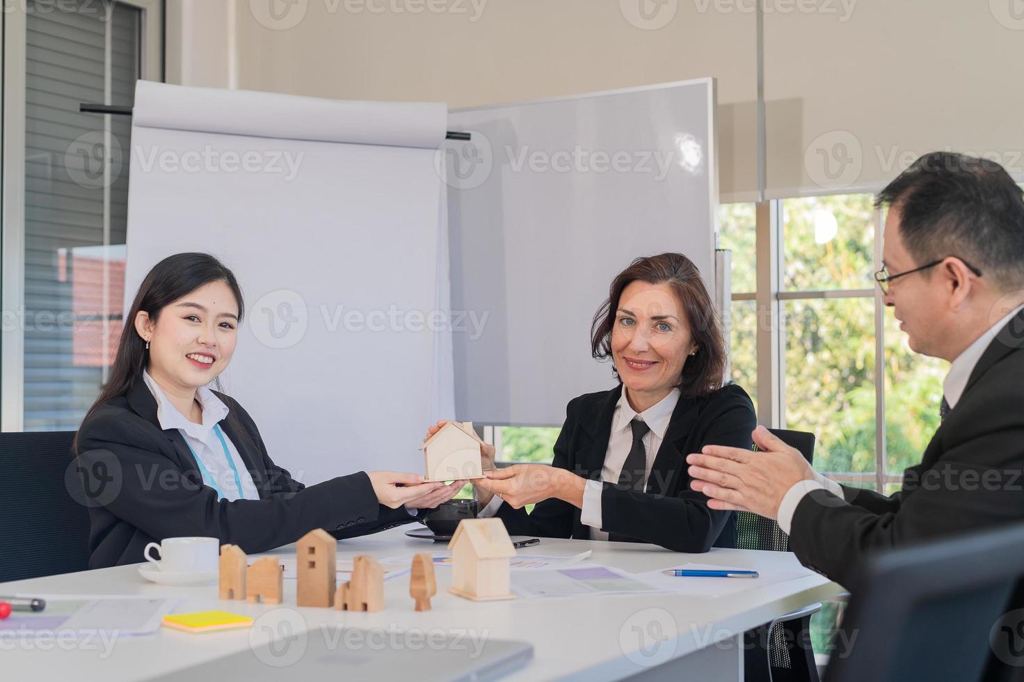 saleswoman presenting a house and housing project for sale at a company meeting. photo