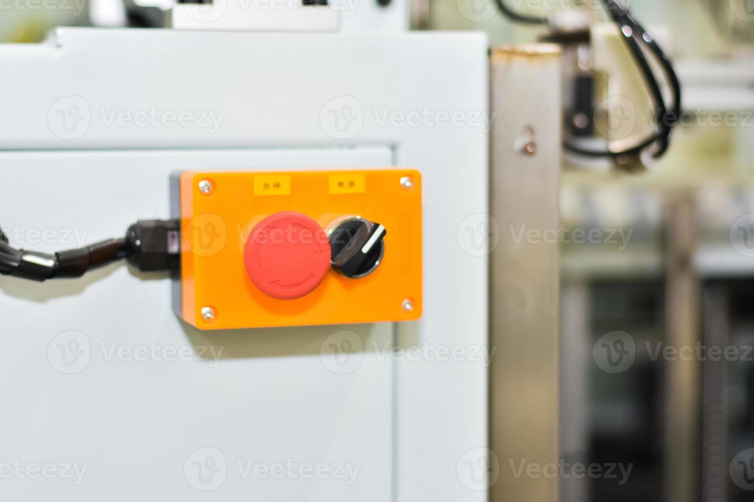 Emergency button for controlling the operation of the machine in the manufacturing industry. photo