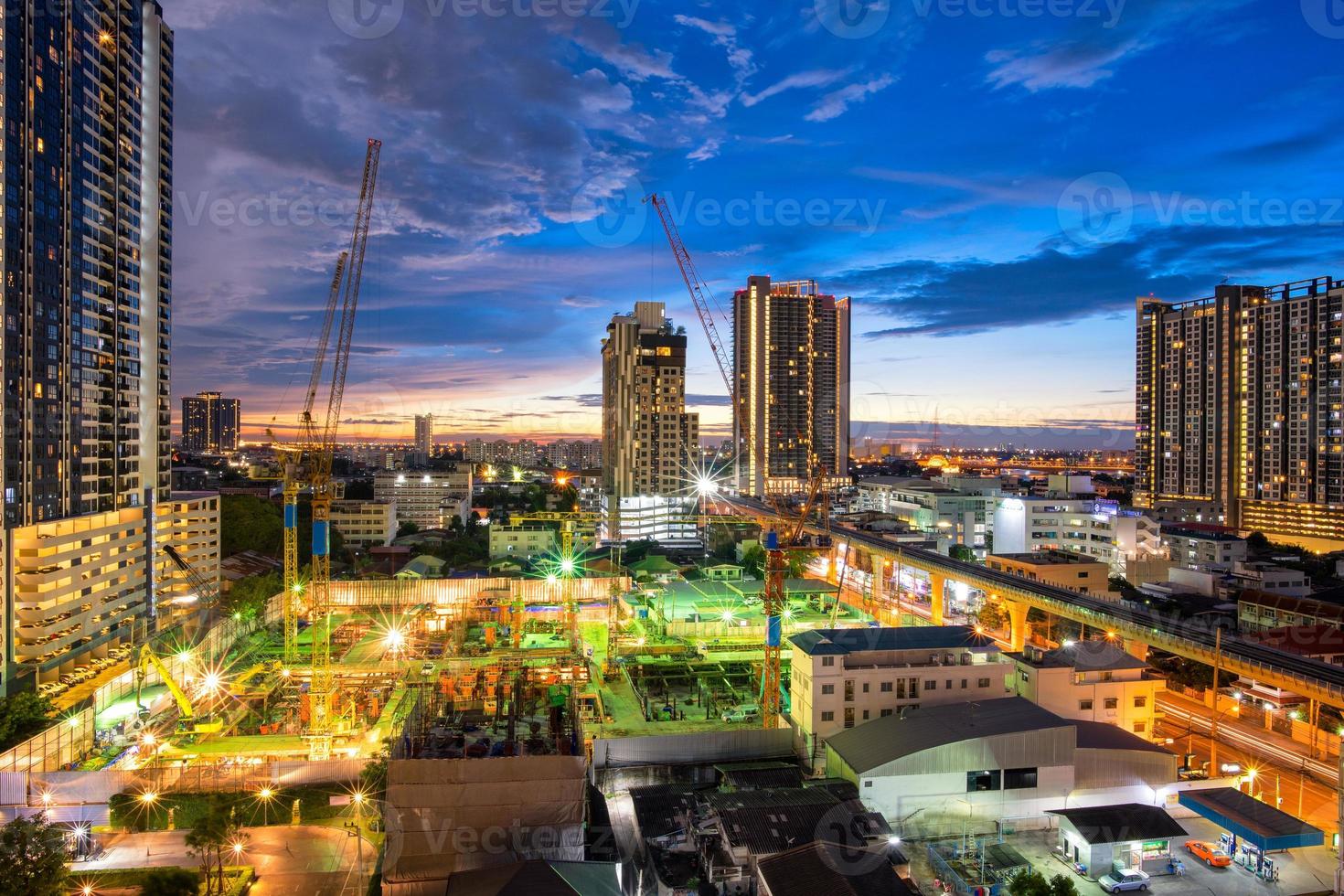 Construction site with backhoe and dump truck busy operate in beginning of building new complex building project in Thailand. photo