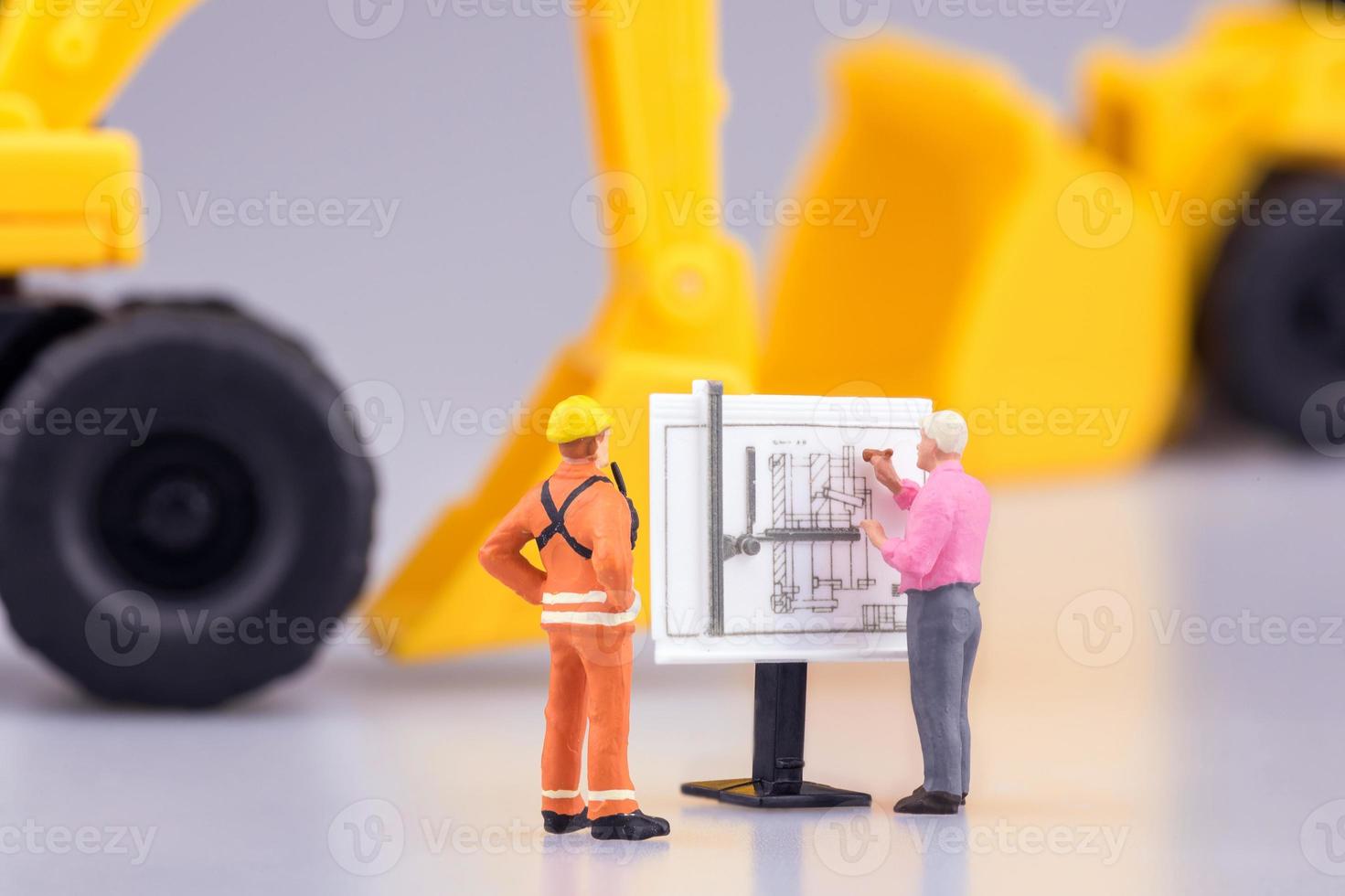 Miniature engineering people and architecture working on construction drawing. Elegant Design for industrial and construction concept. photo