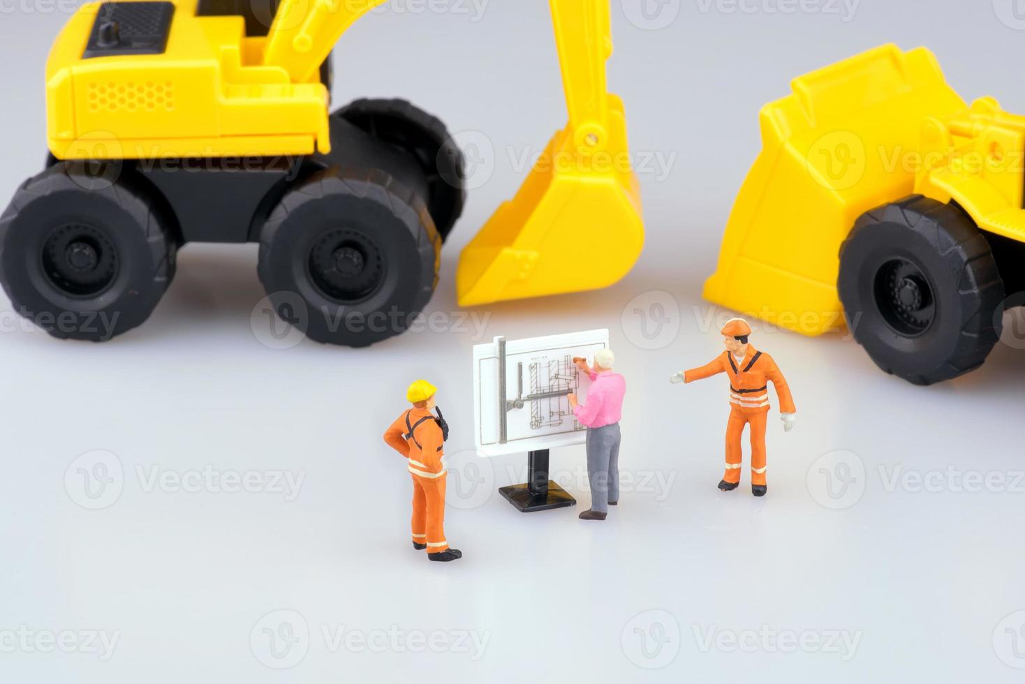 Miniature engineering people and architecture working on construction drawing. Elegant Design for industrial and construction concept. photo