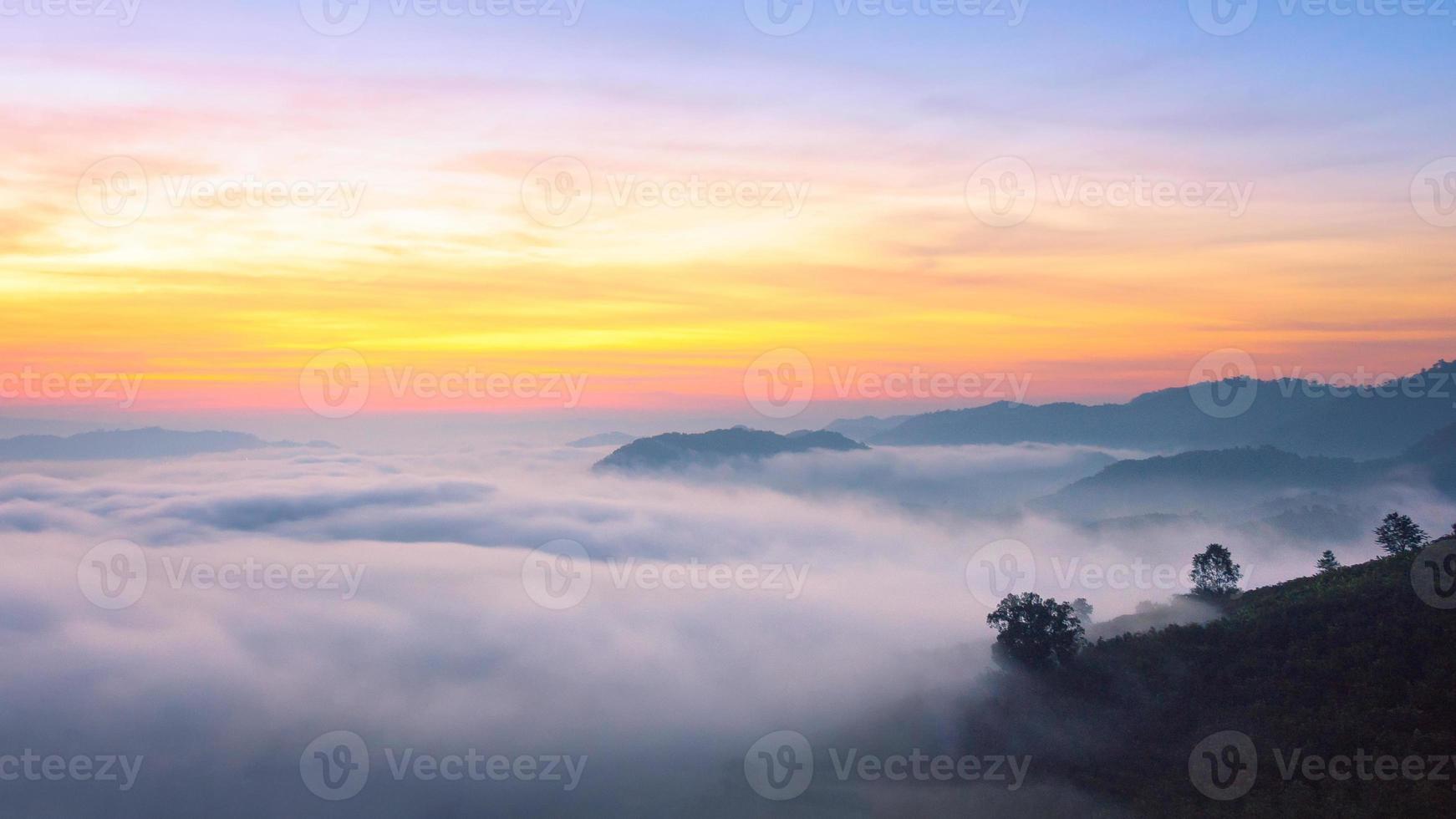 Panorama view of amazing mist moving over the nature mountains during sunrise at mountains area in Thailand. photo