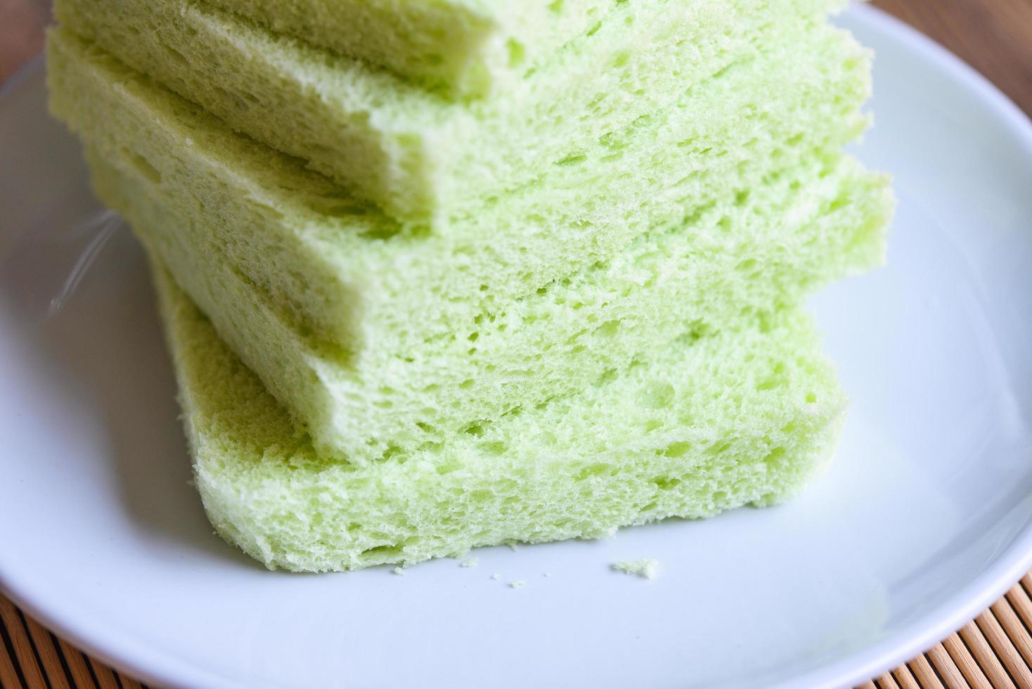 Sliced bread on white plate, Green pandan bread sandwich photo