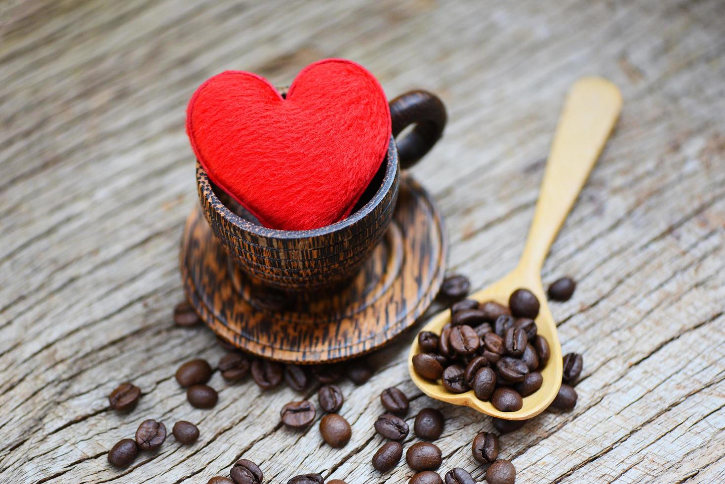 Love coffee concept - Heart in wooden coffee cup with coffee beans romantic love valentines day on wood background photo