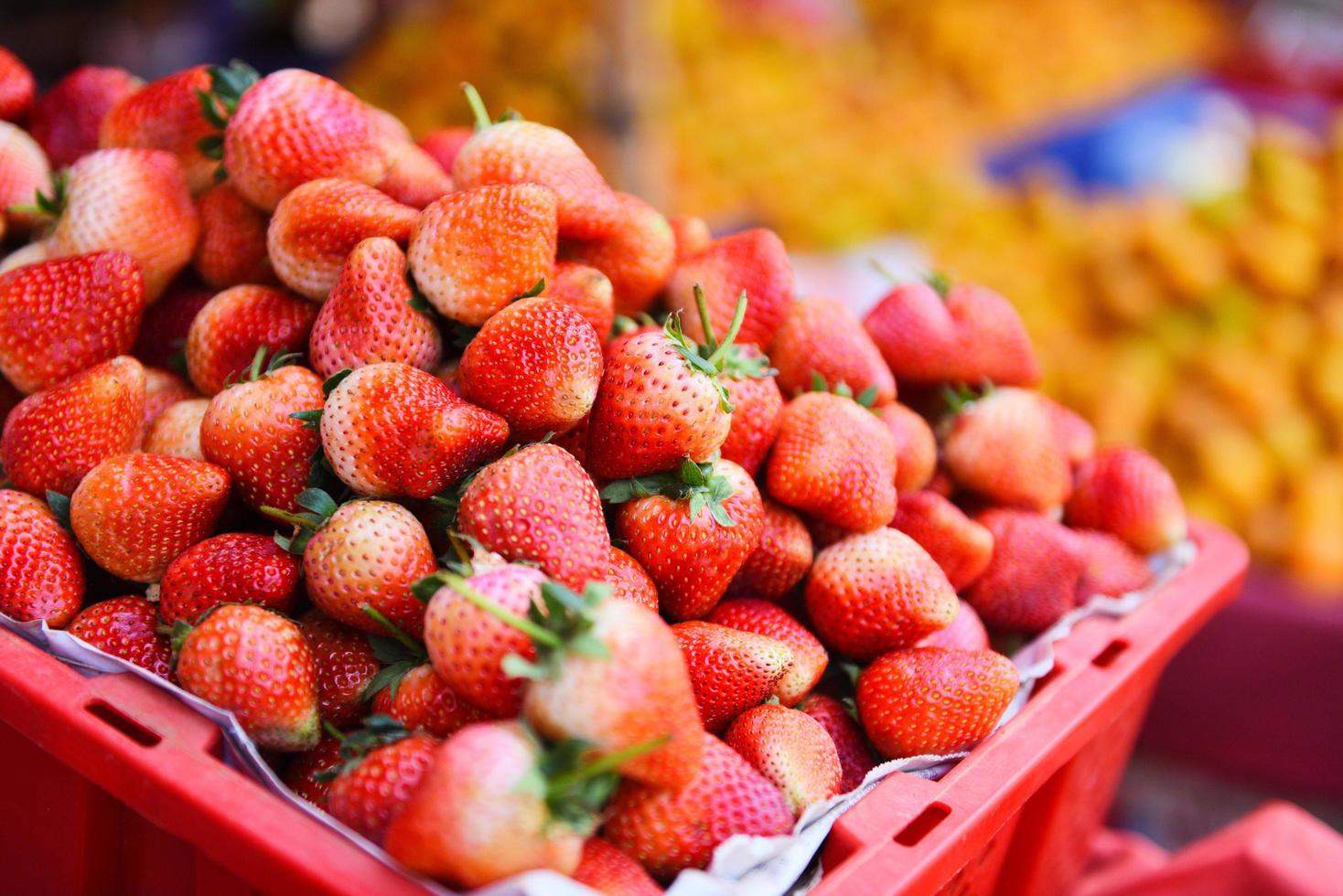 Pile of ripe strawberry in basket for sale in the market fruit - harvested fresh strawberries background photo