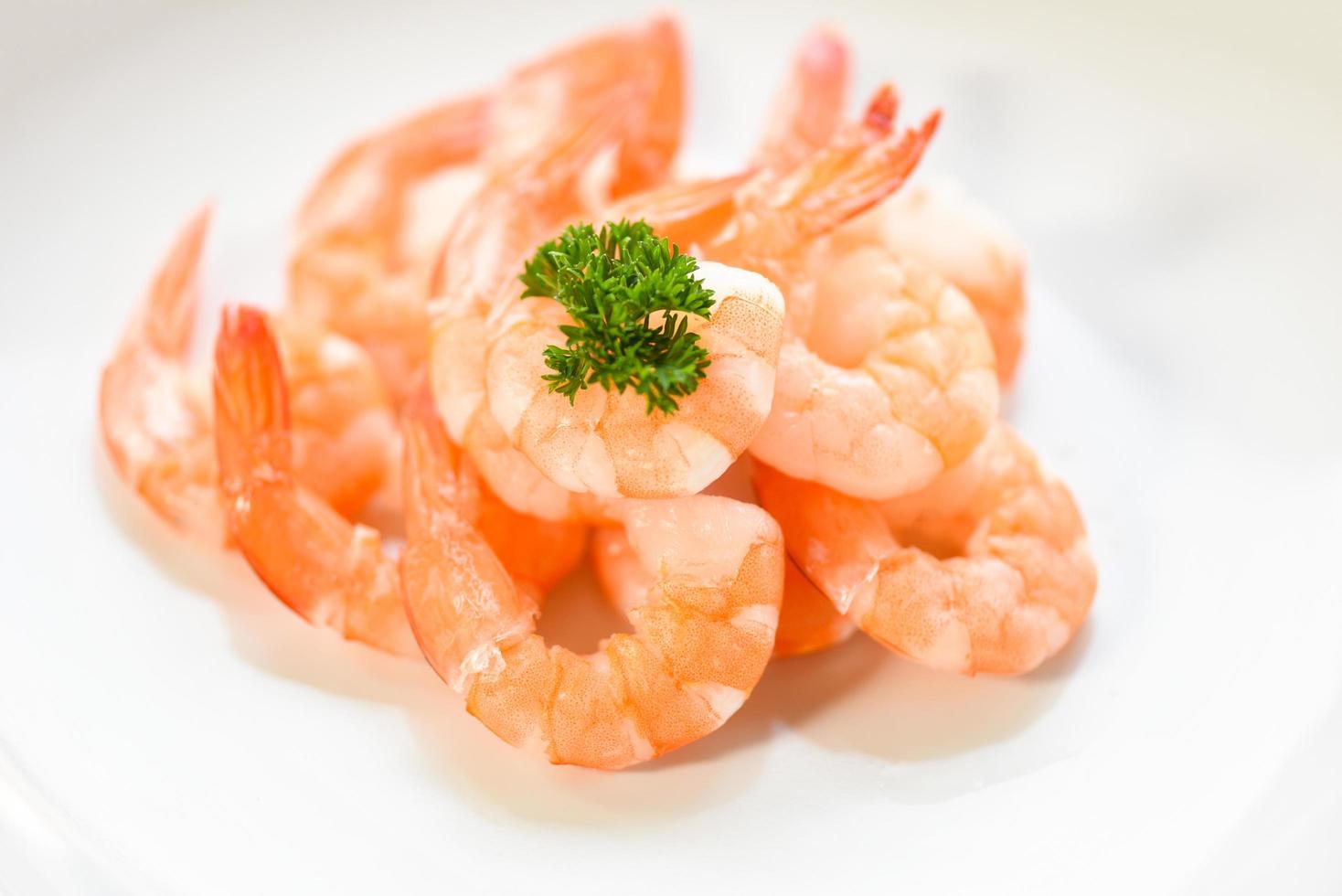 fresh shrimps served on plate - boiled peeled shrimp prawns cooked in the seafood restaurant photo