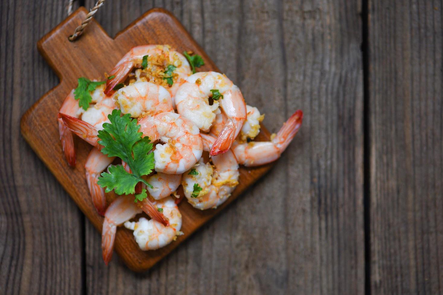 Shrimp delicious seasoning spices on wooden cutting board background - cooked shrimps or prawns , Seafood shelfish photo