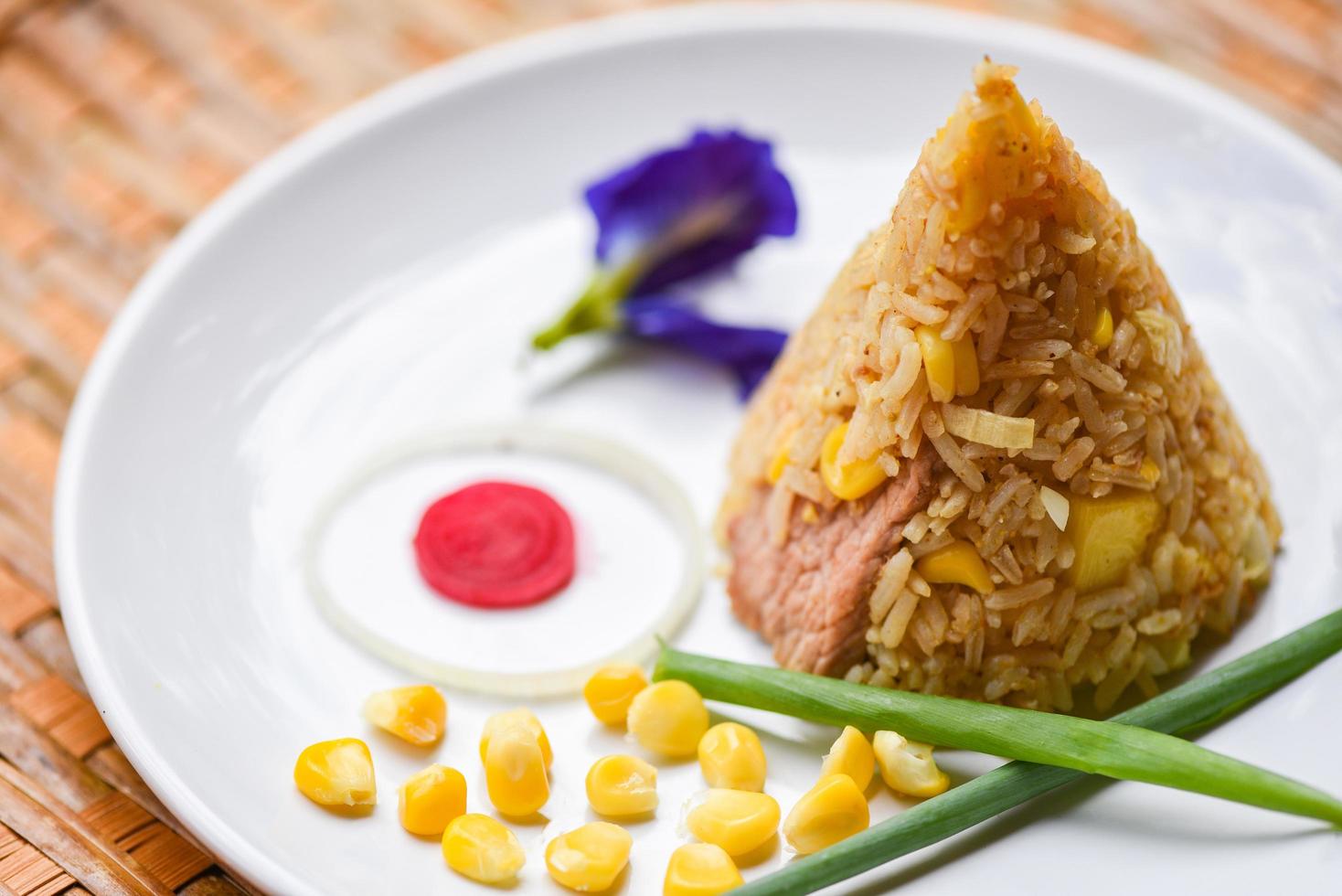 fried rice corn on white plate asian food in thai photo