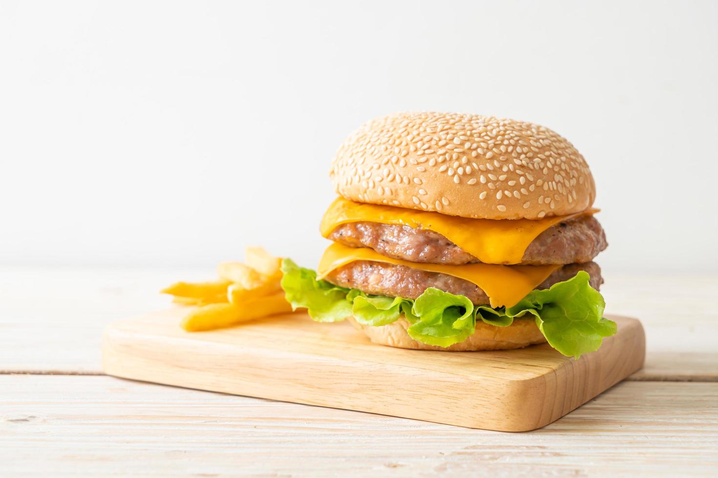 pork burger with cheese and french fries photo