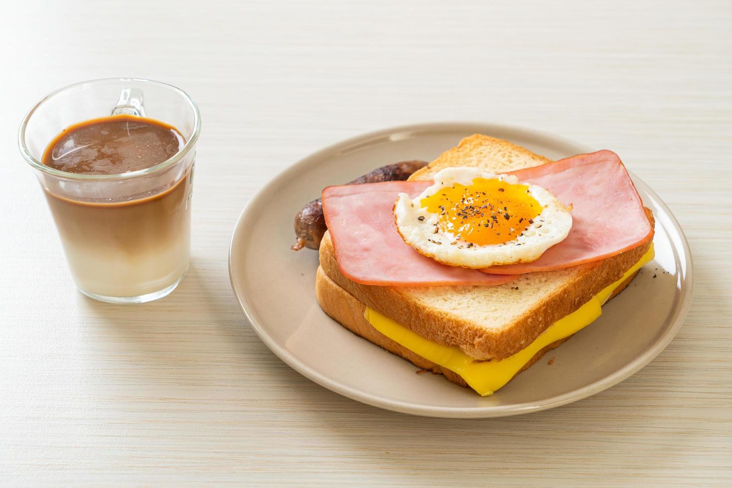 bread toasted cheese topped ham and fried egg with pork sausage photo