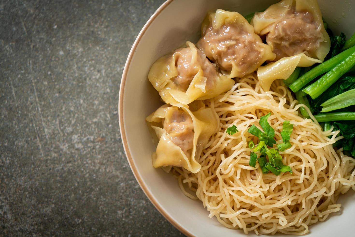 dried egg noodles with pork wonton or pork dumplings without soup photo