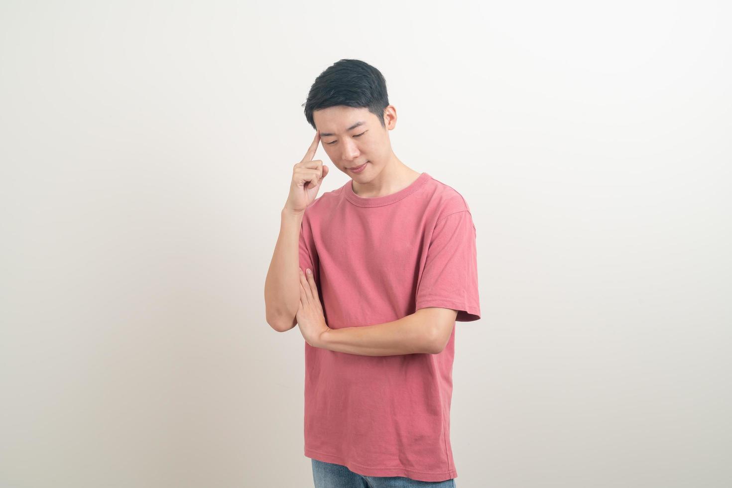 young Asian man thinking on white background photo