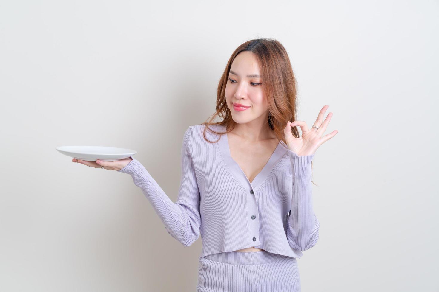 portrait beautiful Asian woman holding empty plate photo