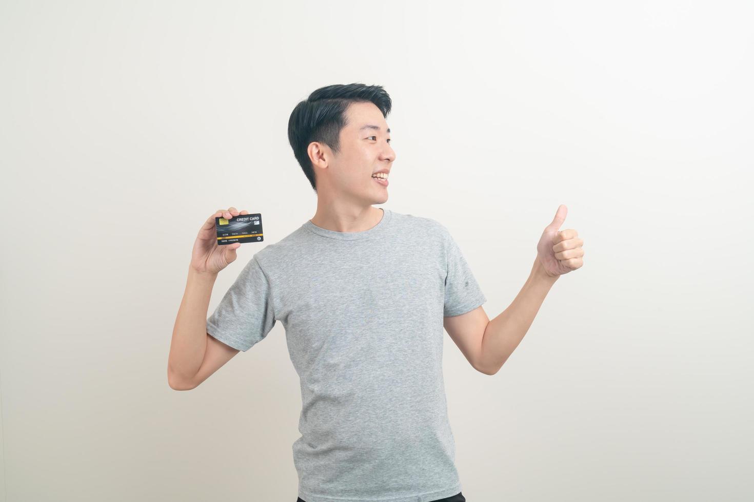 young Asian man holding credit card photo