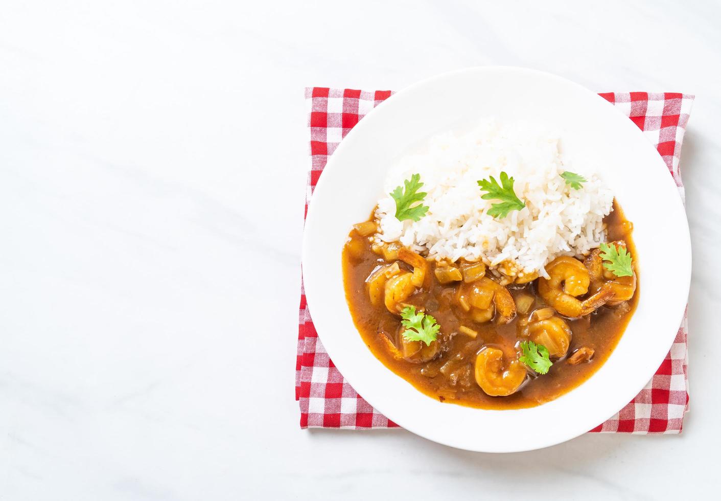 Shrimps in curry sauce on rice photo