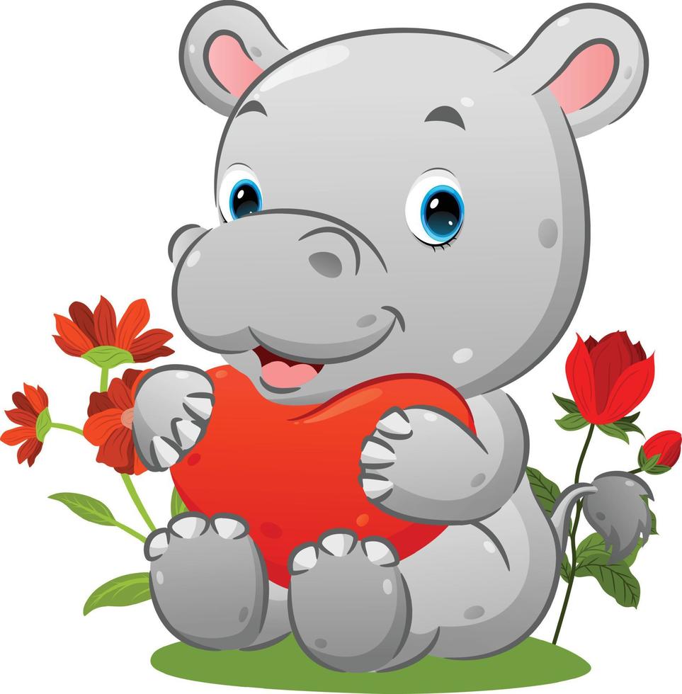 el lindo hipopótamo está sentado en la hierba y sosteniendo el globo del corazón en el jardín vector