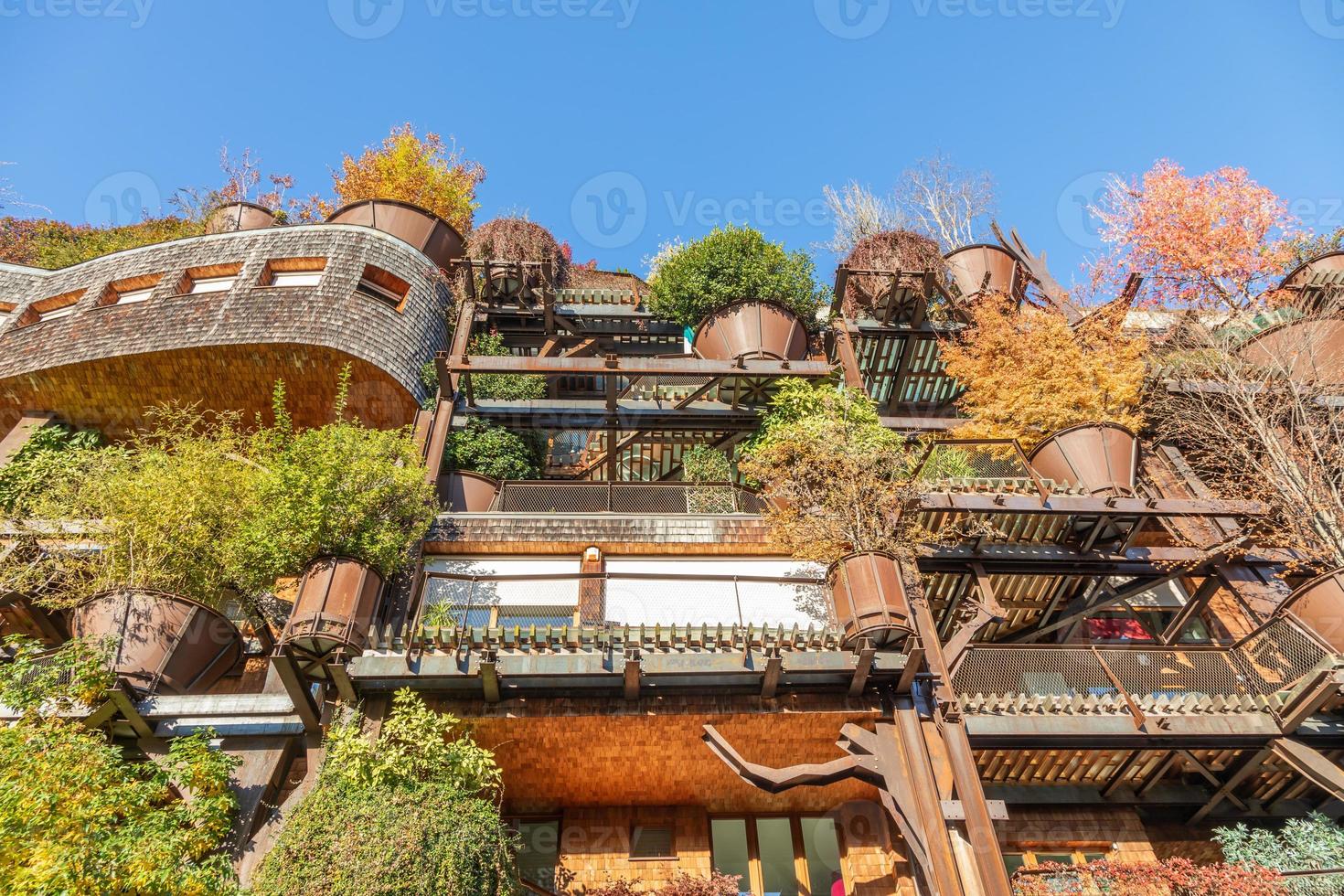 Real estate green residential building in Turin, Italy. Exterior with modern design, plants and wood integrated. photo