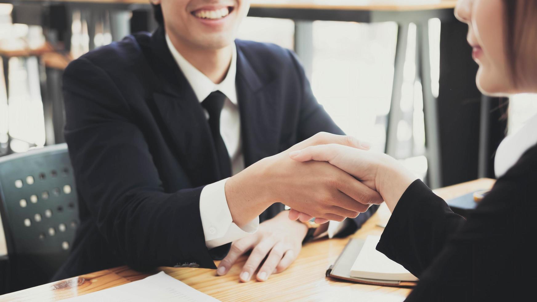 Close up of Business people shaking hands, finishing up meeting, business etiquette, congratulation, merger and acquisition concept photo