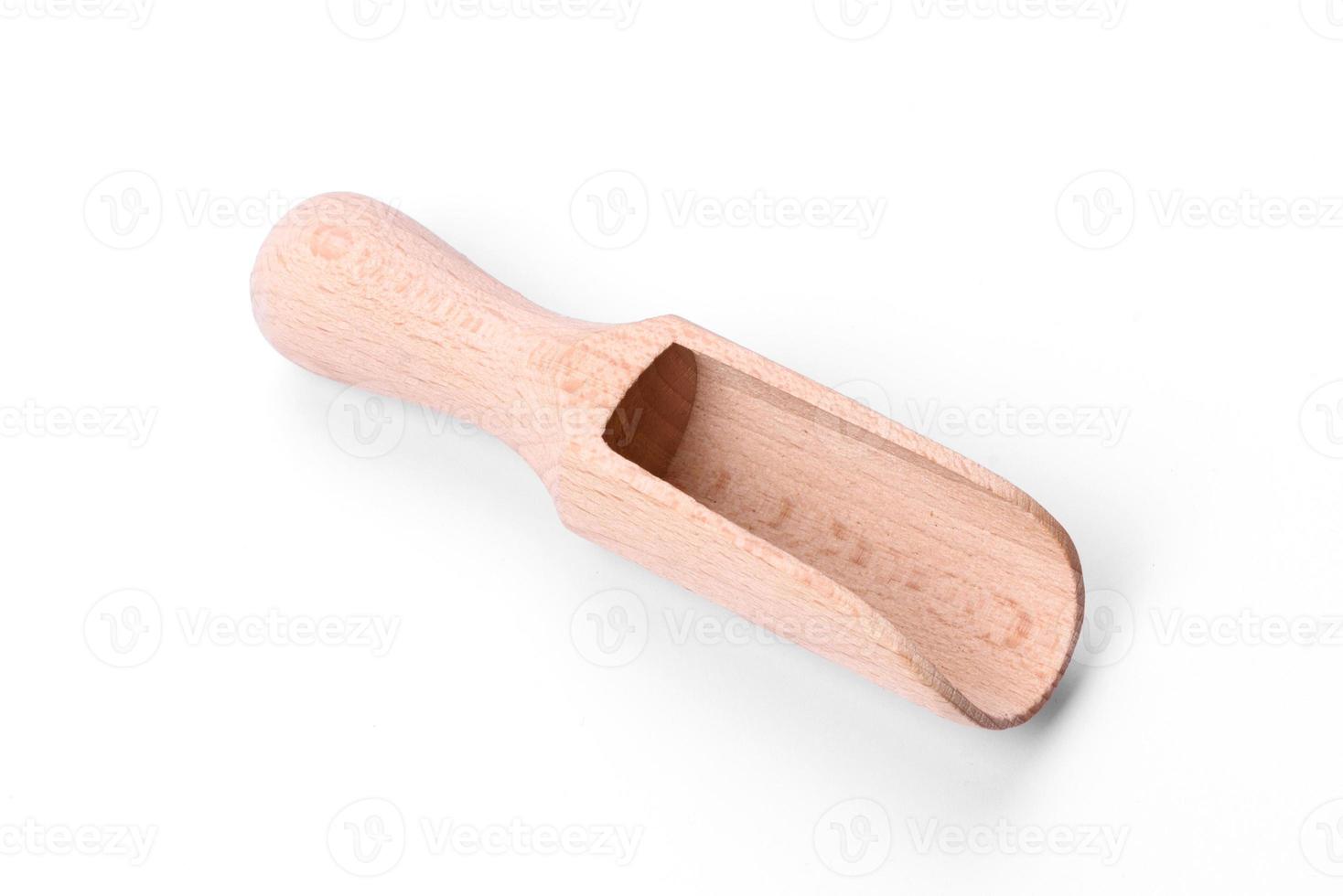 Beautiful wooden scoop for dosing loose products on a white background photo