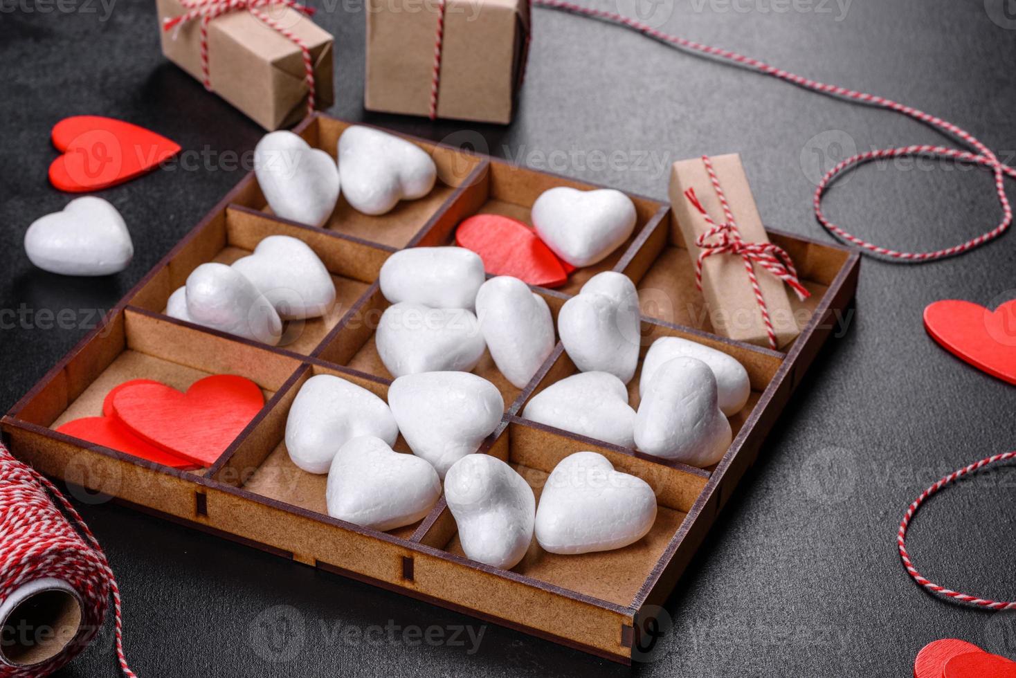 Beautiful background with white and red hearts on a dark table photo