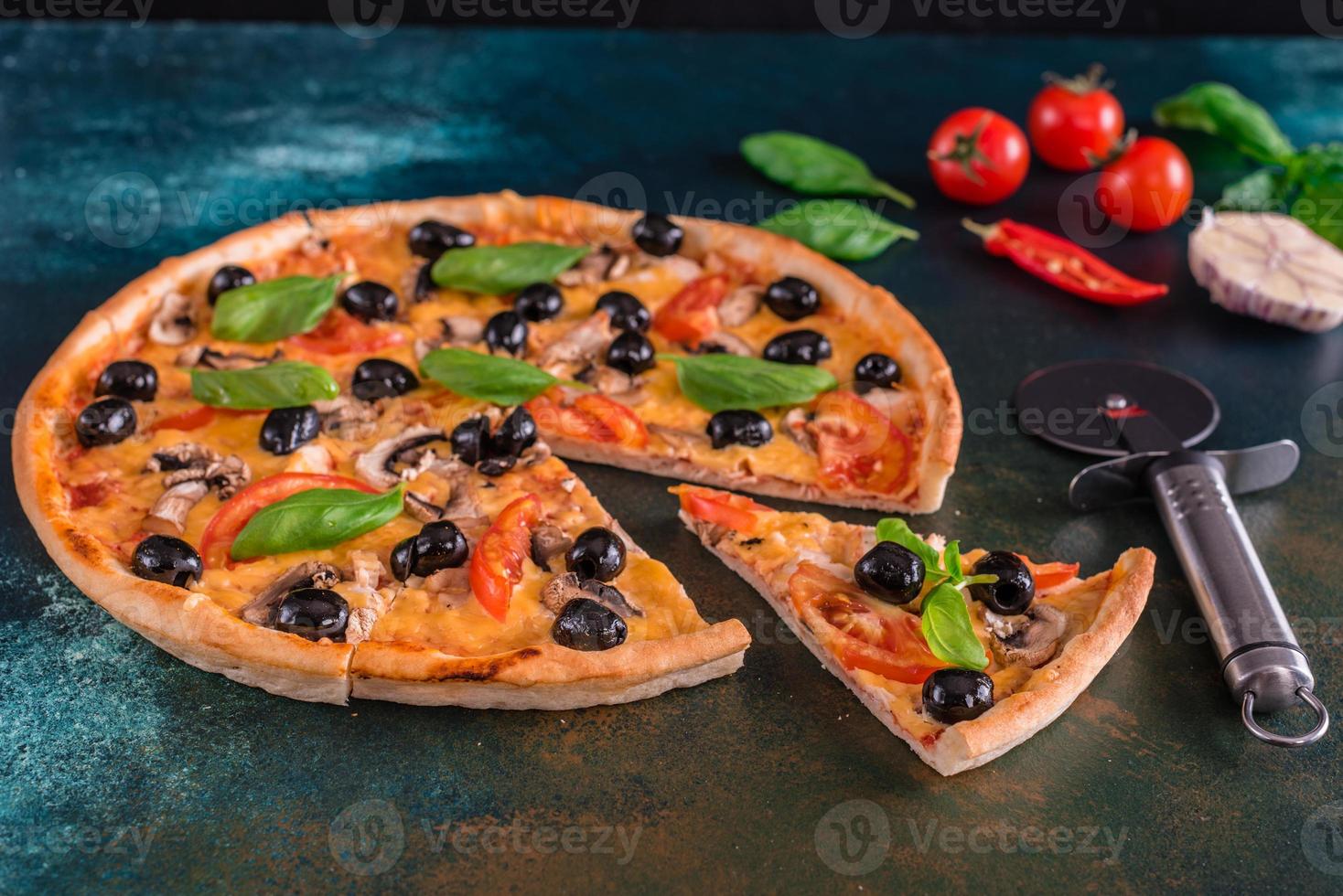 Delicious pizza with olives and chicken on wooden table photo