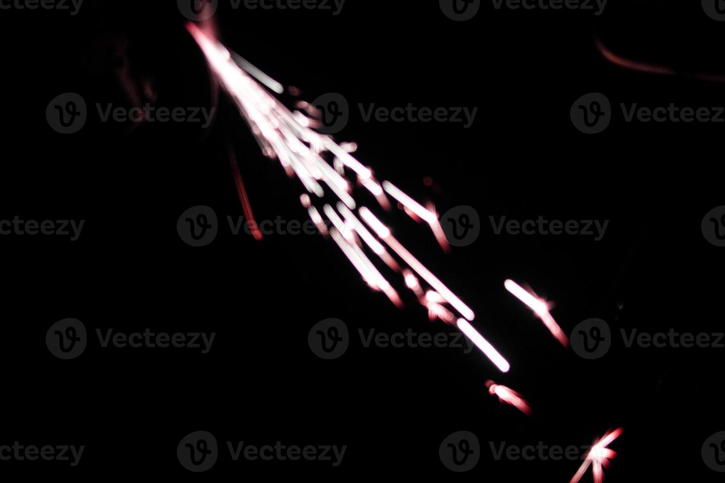 abstract lite red sparkler overlays elegant texture blur sparkling on black. photo