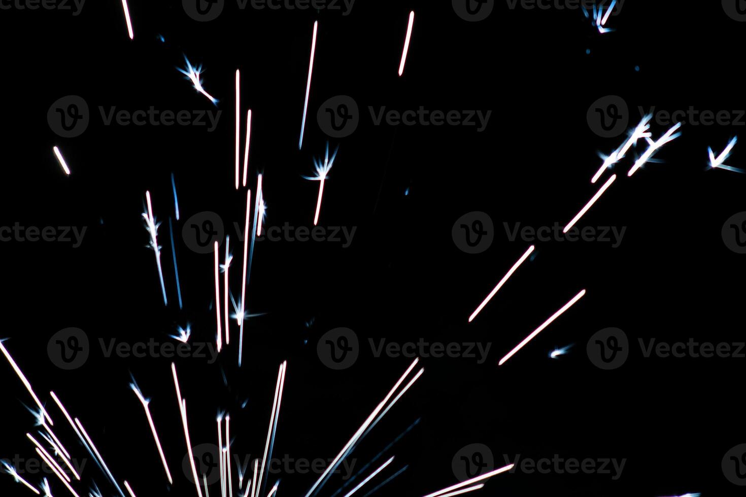 abstract white and lite blue sparkler overlays elegant texture blur sparkling on black. photo