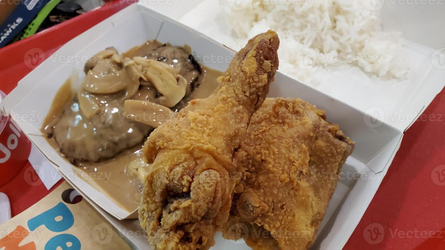 Fresh delicious crispy fried chicken golden brown on white box. photo