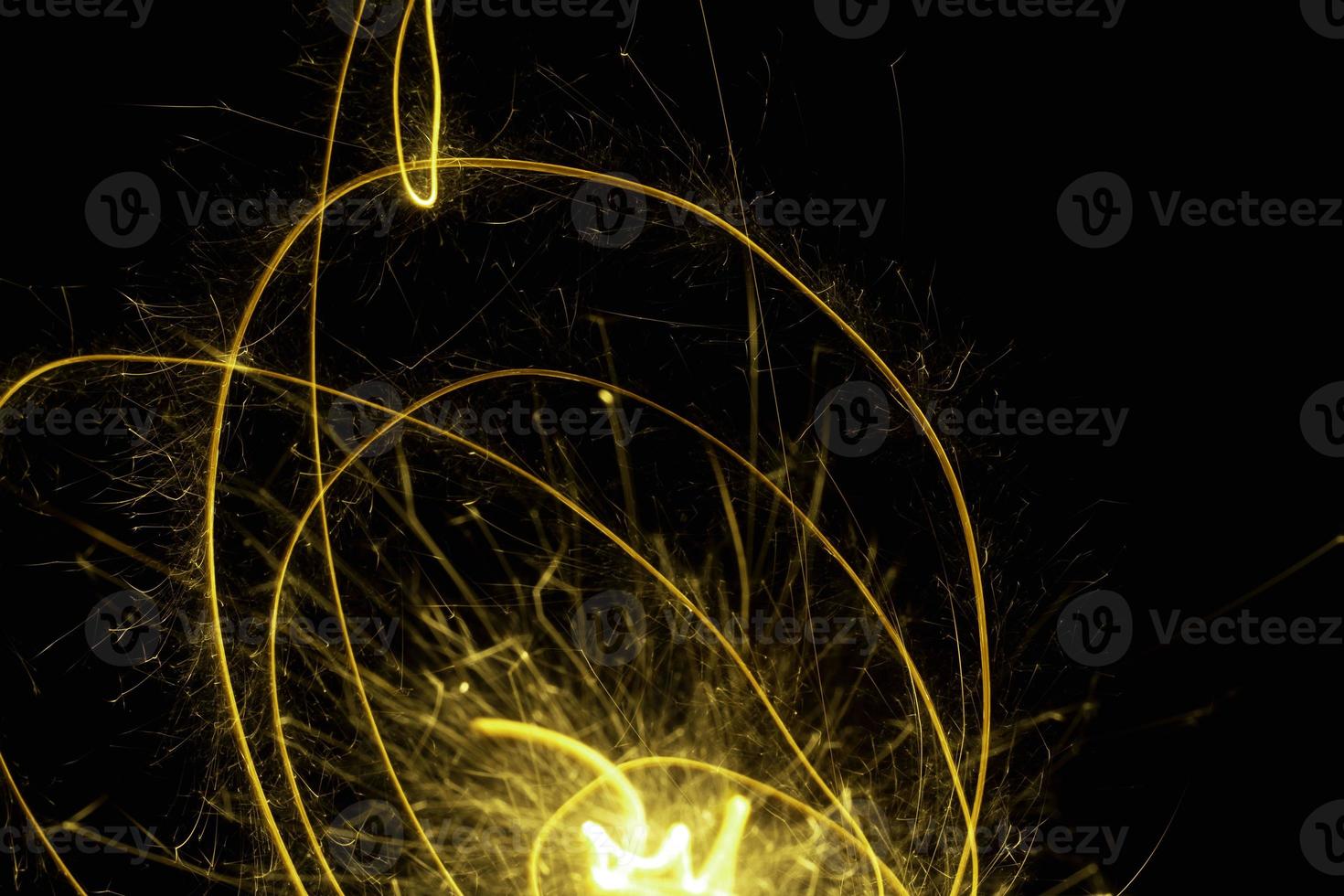 abstract circle gold light trail glowing spiral stylish light effect on a black. photo