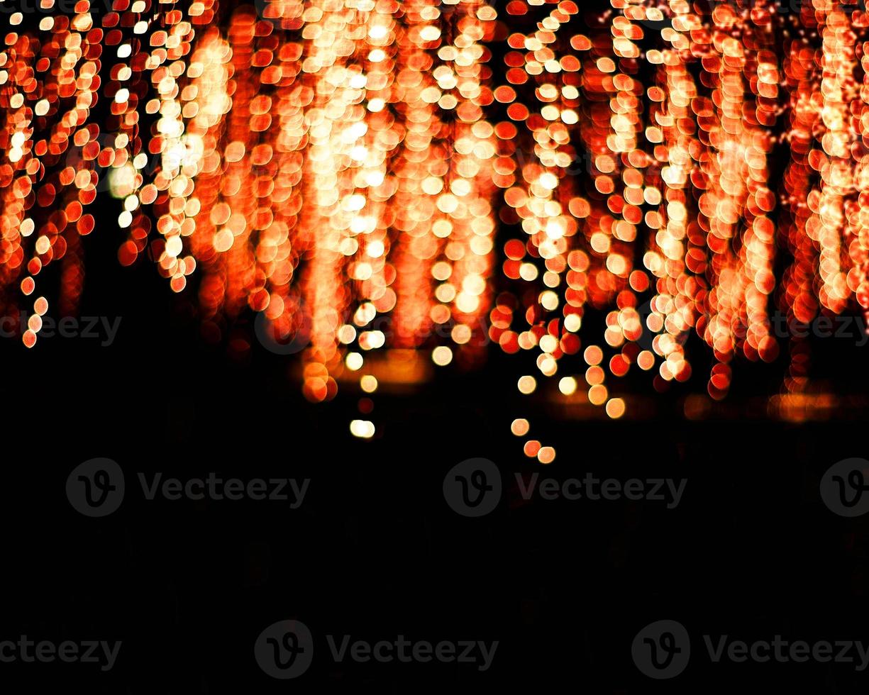 orange blur christmas lights background.abstract Lights unfocused blur light dots black . photo