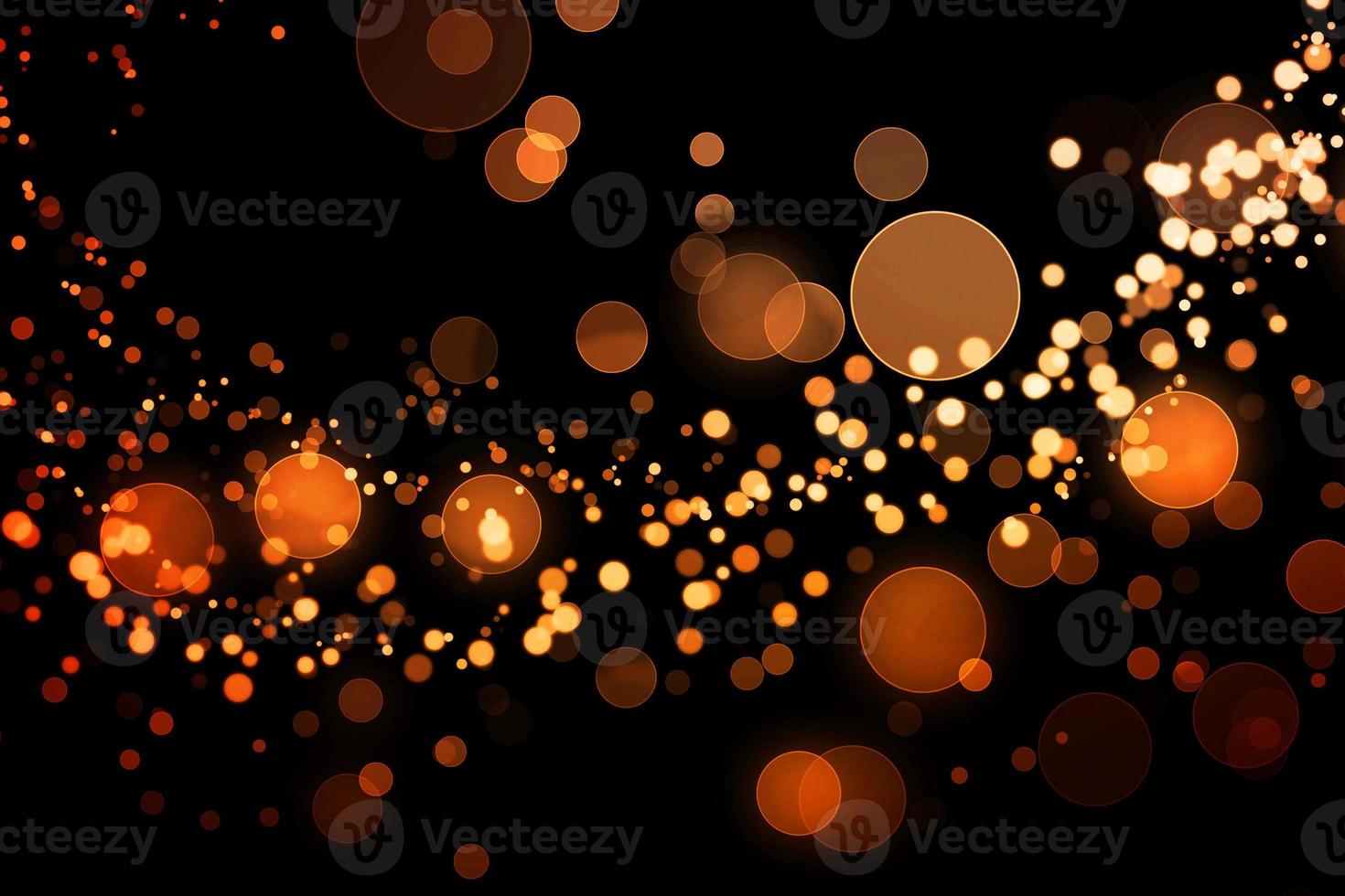 orange blur effect black background.abstract black unfocused blur light dots black . photo