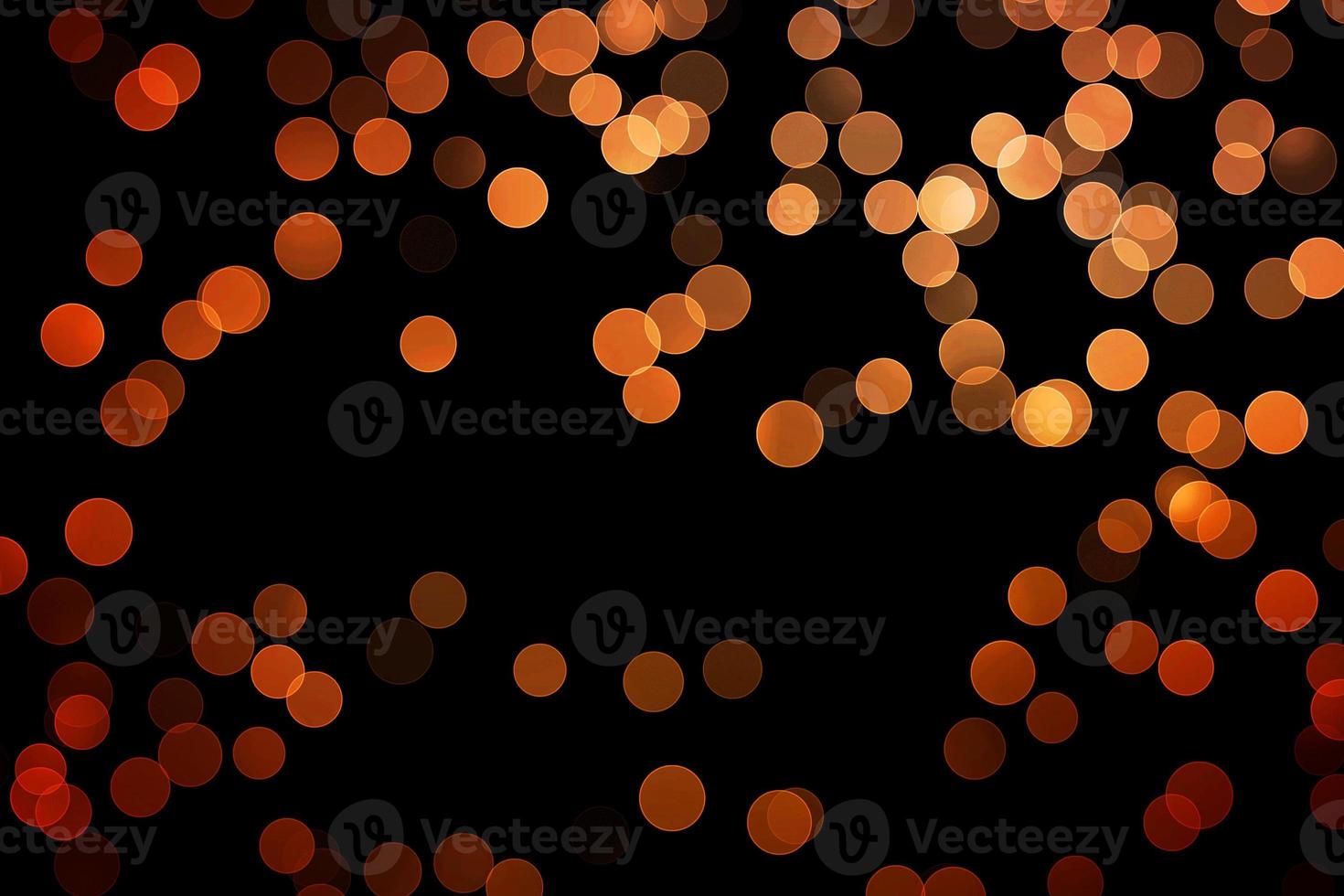 orange blur effect black background.abstract black unfocused blur light dots black . photo